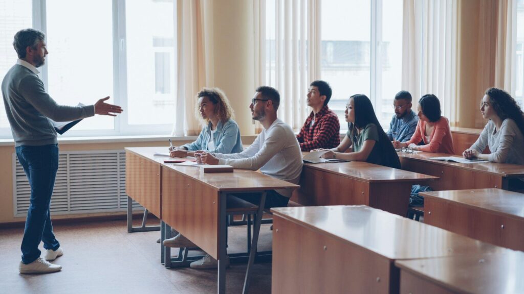 Teacher lecturing students in a classroom setting